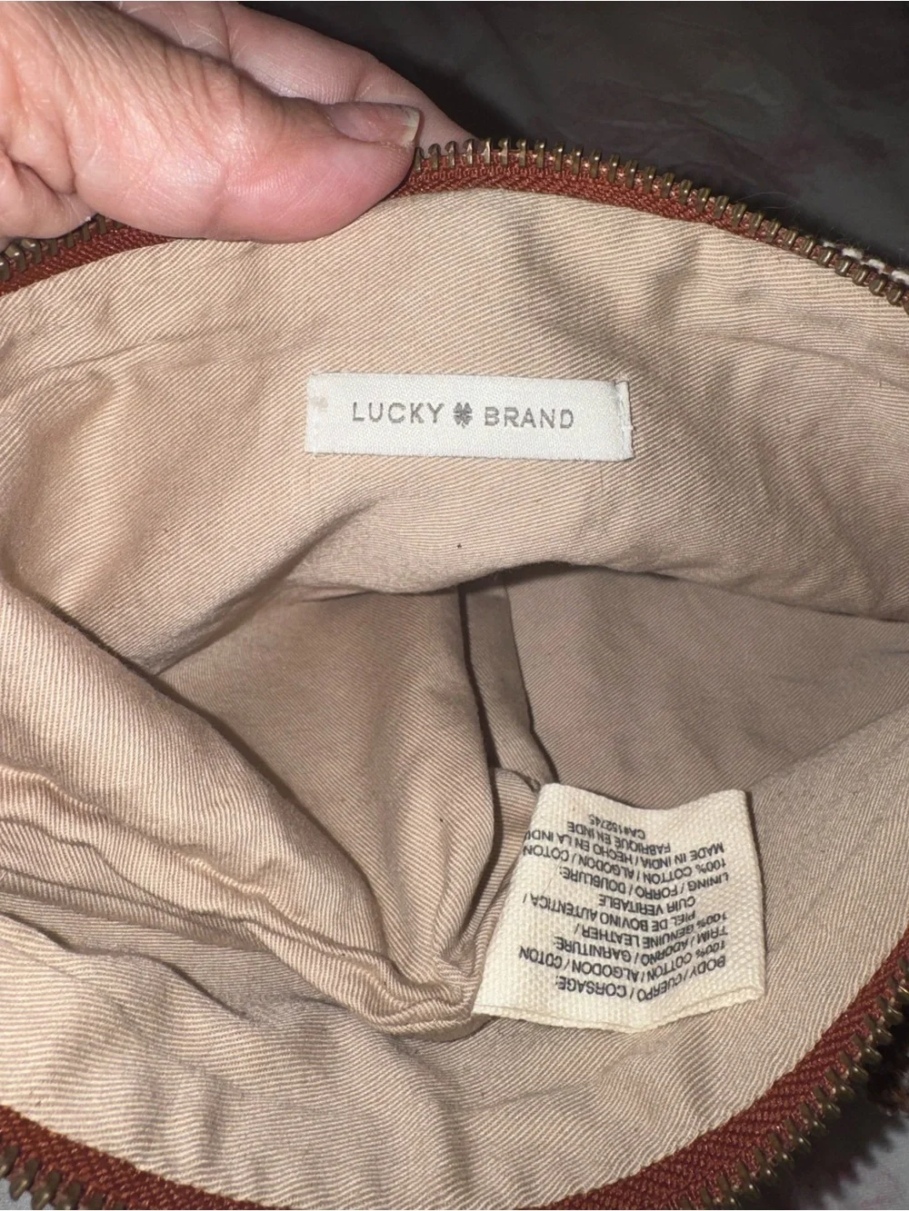 Never worn…Women's Lucky Brand  Brown Patterned Knit Clutch with Pom Tassel
